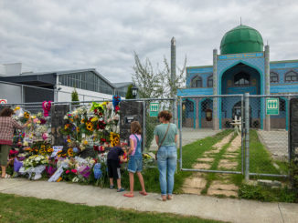 Neighbours laying flowers at Imam Reza Mosque, the day after the massacre at Al Noor Mosque in Christcurch, New Zealand, CC. By Nick.