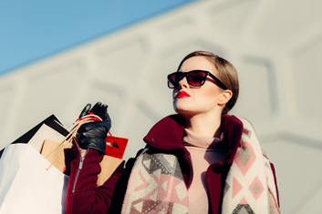 A fashionable woman holding paper bags