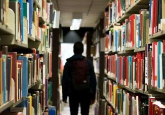 An international student walking at the library.