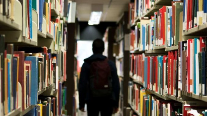 An international student walking at the library