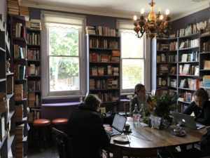 Female students on laptops in Ampersand shop