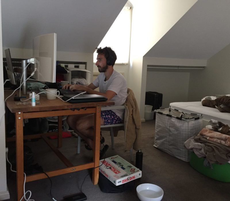 Housemate in his bedroom working on computer