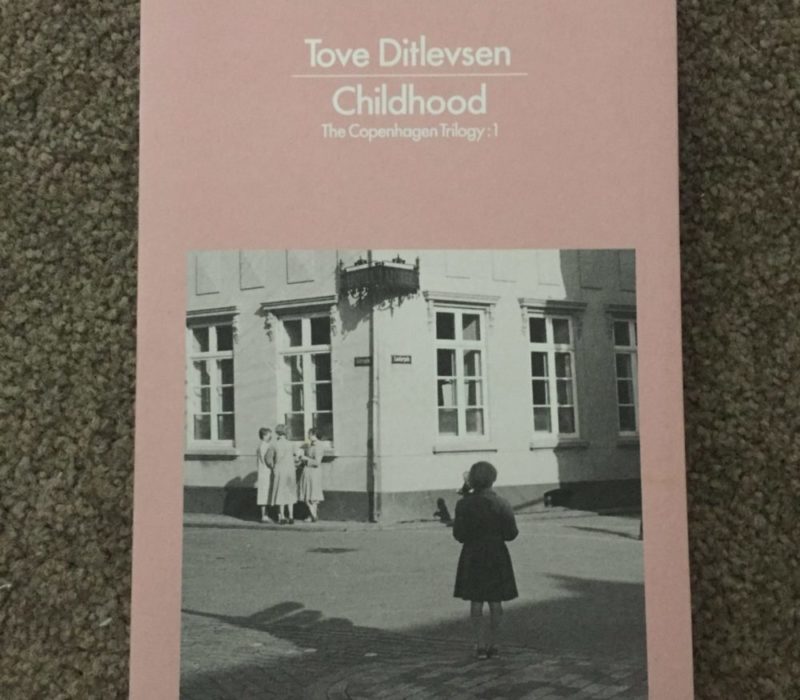 A pink book by Tove Ditlevsen, called Childhood