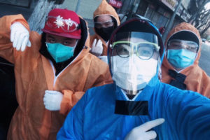 A selfie of team members wearing protective cloth