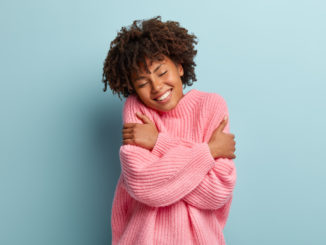 Girl hugging herself