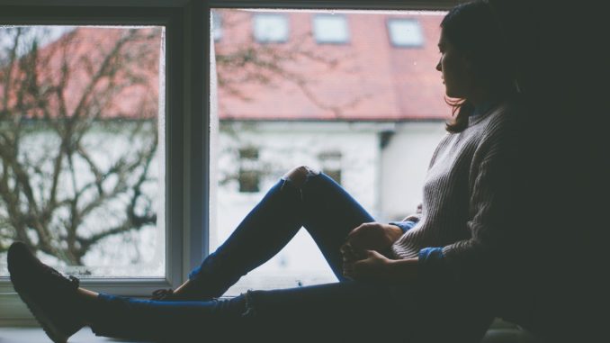 Young girl sitting next to the window