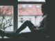 Young girl sitting next to the window